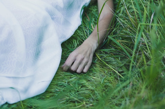 Crop woman on grass