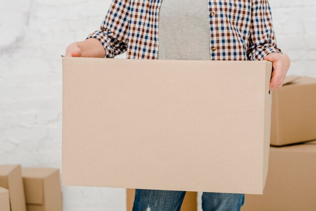 Crop woman holding box