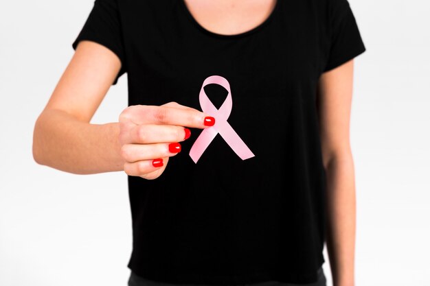 Crop woman holding breast cancer ribbon