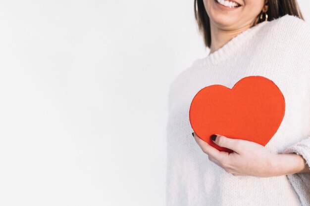 Crop woman holding heart