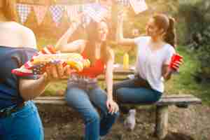 Free photo crop woman holding hot-dog