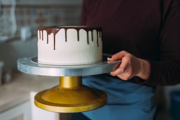 Crop woman holding palatable cake