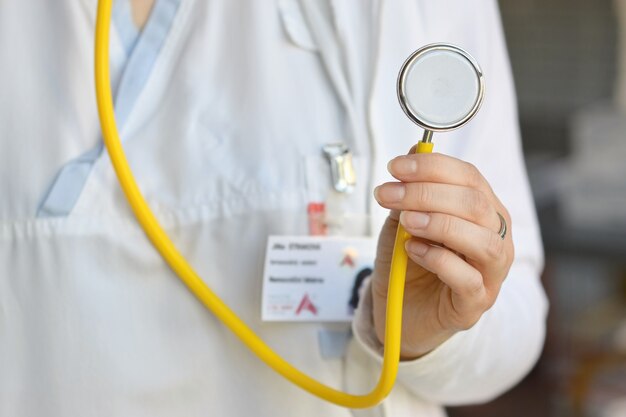 "Crop woman holding stethoscope"