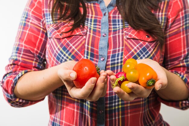 Crop woman holding vegetables in hands