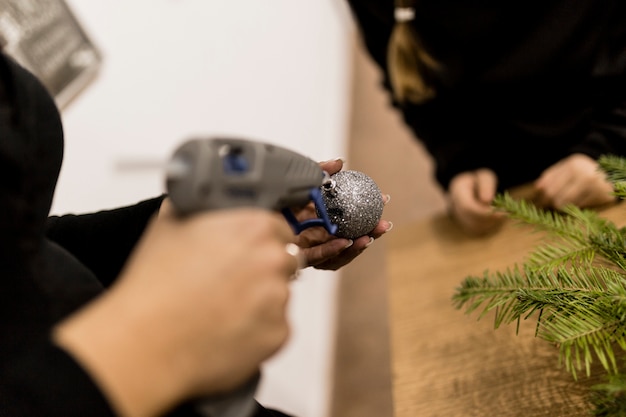 Free photo crop woman making bauble