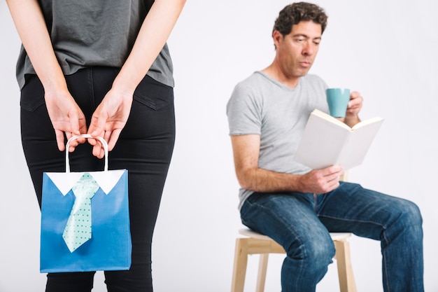 Crop woman making surprise for reading father