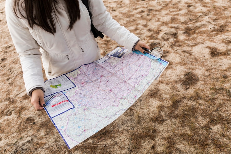 Free Photo crop woman reading map on shore