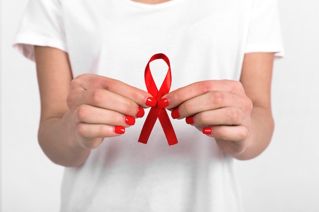 Crop woman showing burgundy ribbon