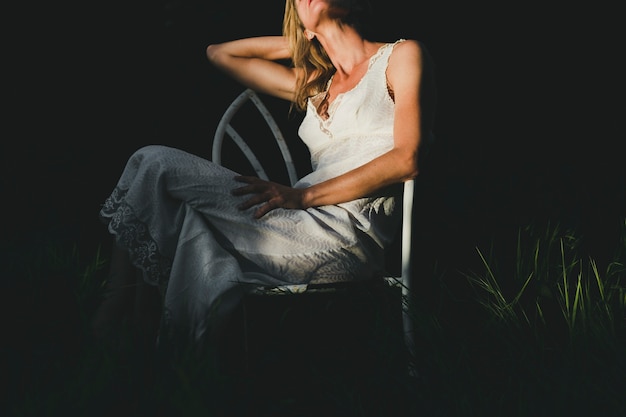 Crop woman sitting on chair