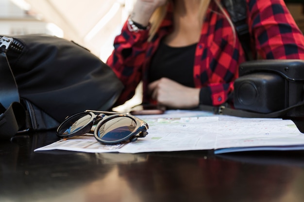 Free photo crop woman sitting at table during trip