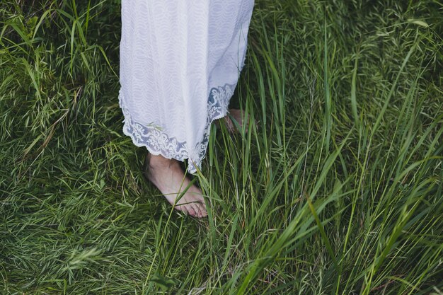 Crop woman standing on grass