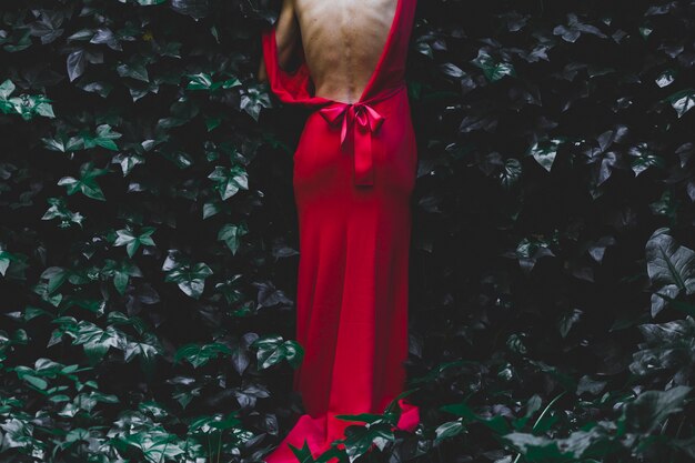 Crop woman stepping into bush