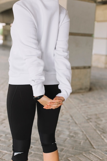 Crop woman stretching back