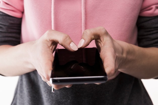 Crop woman using smartphone