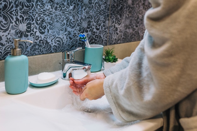 Free photo crop woman washing hands