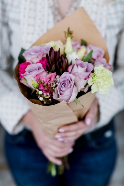 Crop woman with beautiful bouquet