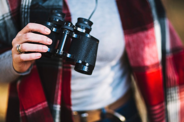 Free photo crop woman with binoculars