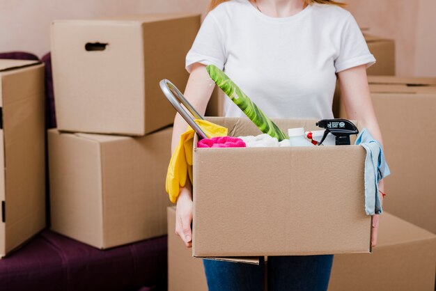 Crop woman with box with things