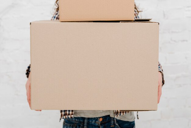 Crop woman with carton boxes