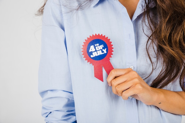 Crop woman with Independence Day badge