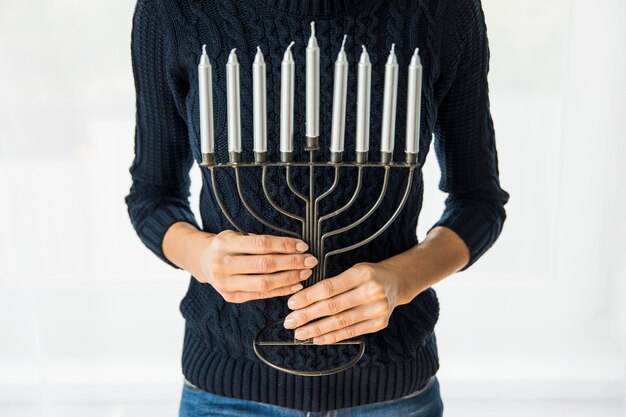 Crop woman with menorah