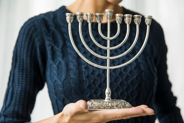 Free photo crop woman with menorah