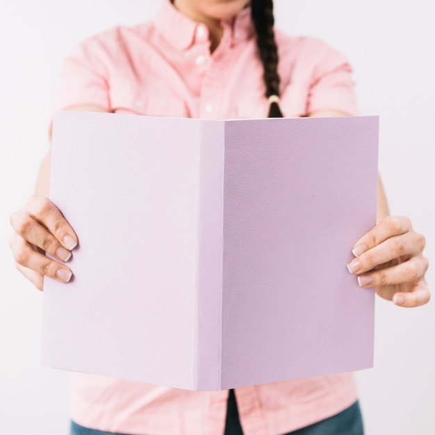 Crop woman with opened book