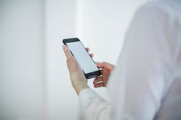 Crop woman with smartphone