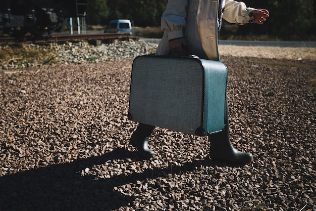 Free photo crop woman with suitcase