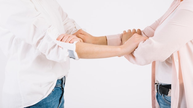 Free photo crop women grasping arms