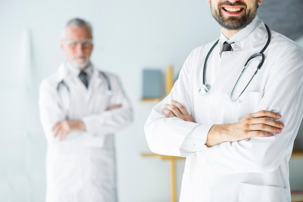 Crop young doctor standing in office