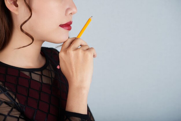 Cropped face of woman with a gesture of creative thinking over the business challenge