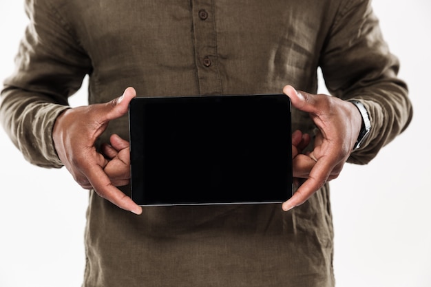 Free photo cropped image of african man showing blank tablet computer screen
