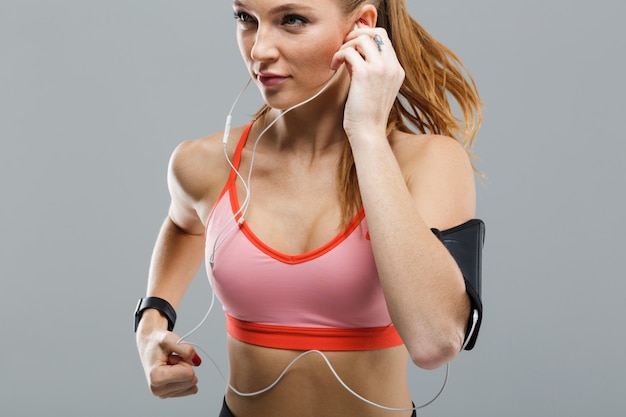 Cropped image of beautiful young sports woman running