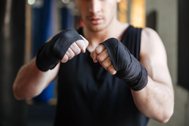 Free photo cropped image of boxer standing in gym