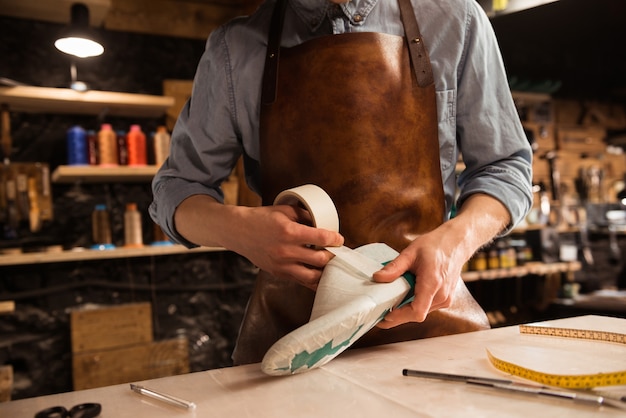 Free photo cropped image of a cobbler modeling design for a shoe