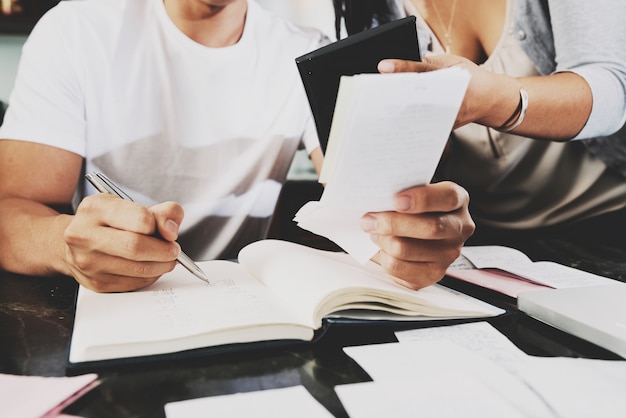 Cropped image of couple counting how much they need to pay bills and mortgage loan