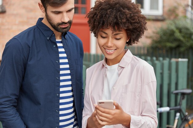 Cropped image of happy diverse friends pose in urban setting