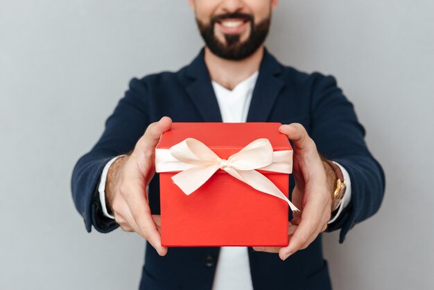 Cropped image of smiling bearded man in business clothes