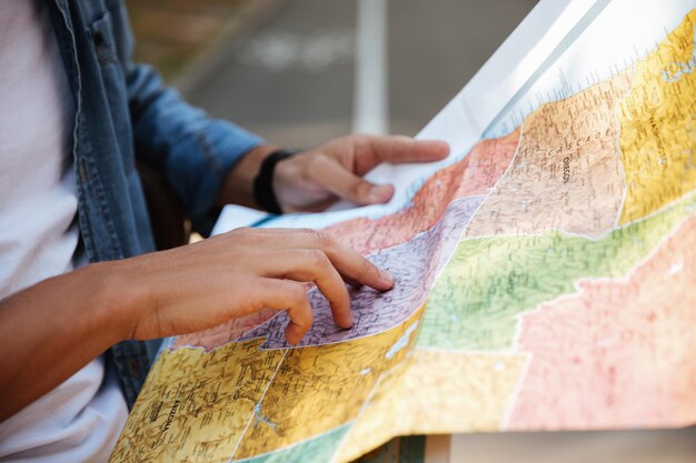 Cropped image of young man looking at map