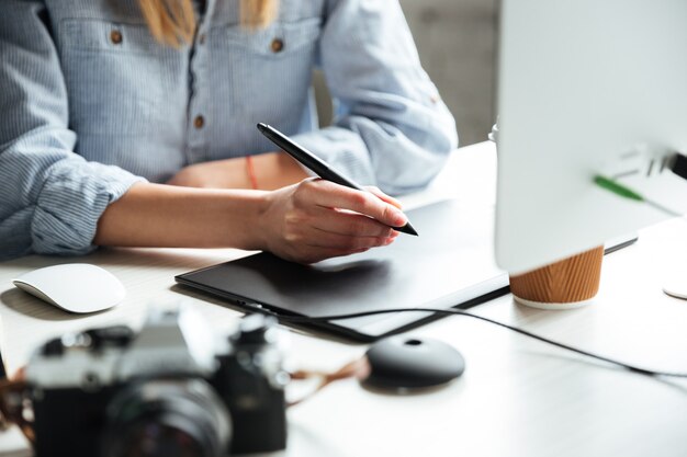 Cropped image of young woman work in office