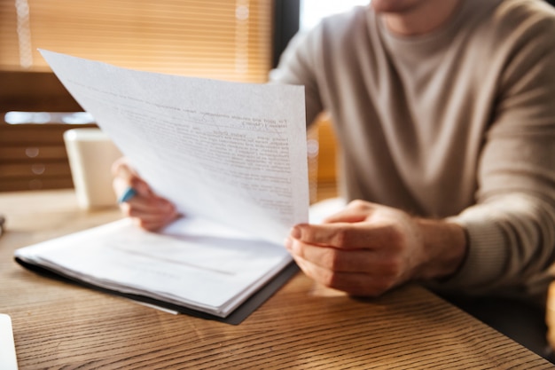 Cropped photo of attractive young man in office working