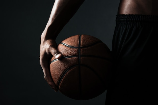 Free photo cropped photo of basketball player holding ball