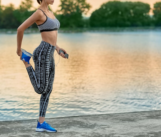 Free photo cropped photo of girl making exercises on fresh air