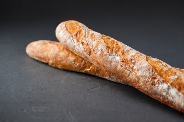 Free photo cropped photo of two french baguettes