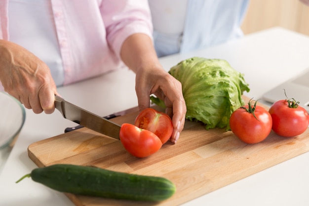 Cropped picture of mature loving couple family cooking.