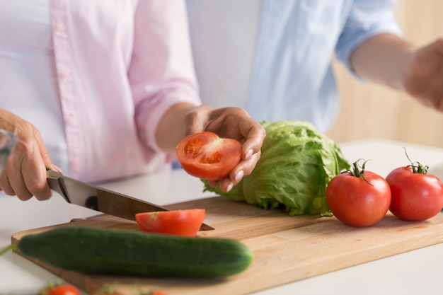 Cropped picture of mature loving couple family cooking.