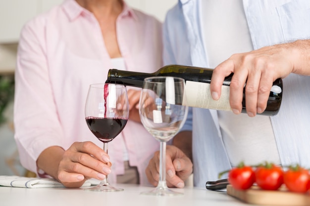 Обрезанное изображение зрелой любящей пары семьи пить вино
