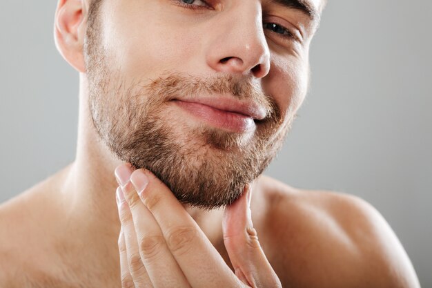 Cropped portrait of a smiling bearded man looking at camera