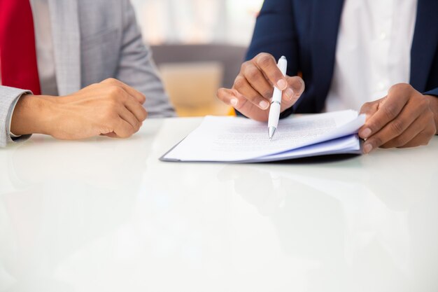 Cropped shot of business people reading contract